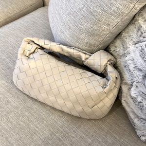 Leather pouch bag with top knot